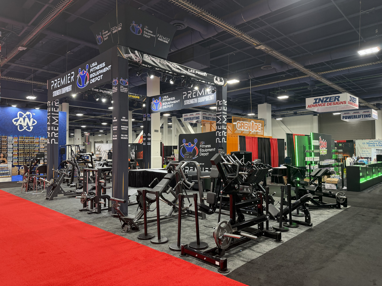 USA Fitness Equipment Depot 20x40 trade show exhibit at Olympia World Fitness Expo 2026, featuring Premier Strength Equipment branding, overhead signage, and commercial gym equipment displays.